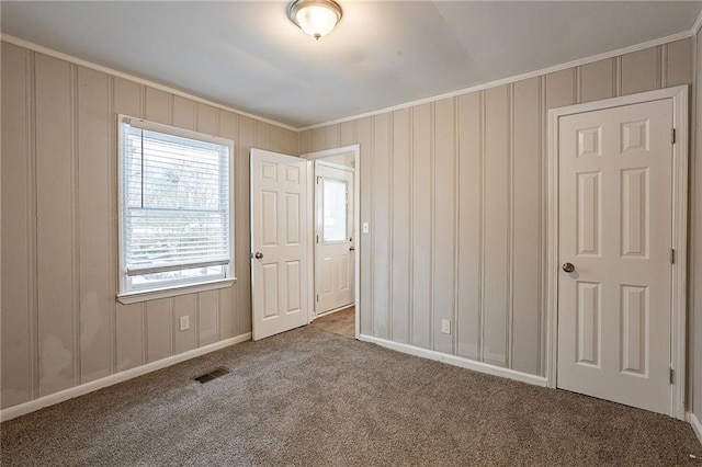 unfurnished bedroom featuring carpet and ornamental molding