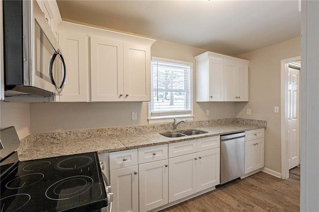 kitchen with sink, white cabinets, and stainless steel appliances