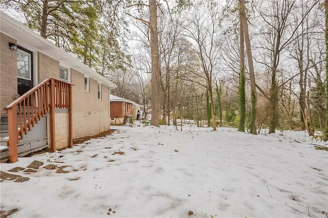 view of yard layered in snow