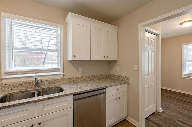 kitchen featuring light stone countertops, dark hardwood / wood-style flooring, white cabinets, sink, and dishwasher