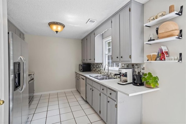 4255 Hidden Meadow Cir, Sugar Hill, GA 30518 - kitchen featuring appliances with stainless steel finishes, a sink, gray cabinets, open shelves, and tasteful backsplash