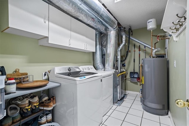 4255 Hidden Meadow Cir, Sugar Hill, GA 30518 - laundry area with gas water heater, cabinet space, washing machine and dryer, light tile patterned floors, and a textured ceiling