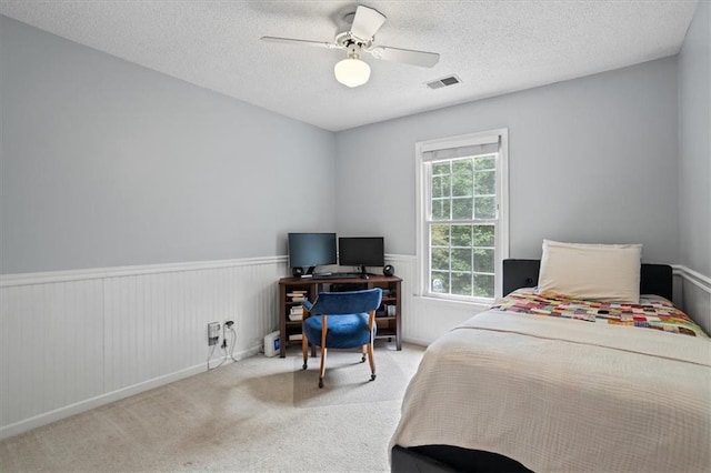 4255 Hidden Meadow Cir, Sugar Hill, GA 30518 - carpeted bedroom with a wainscoted wall, a textured ceiling, and a ceiling fan