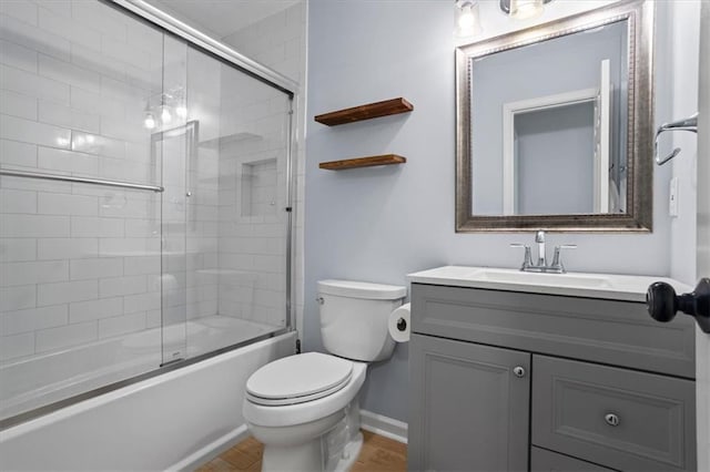 4255 Hidden Meadow Cir, Sugar Hill, GA 30518 - bathroom featuring vanity, toilet, combined bath / shower with glass door, baseboards, and wood finished floors