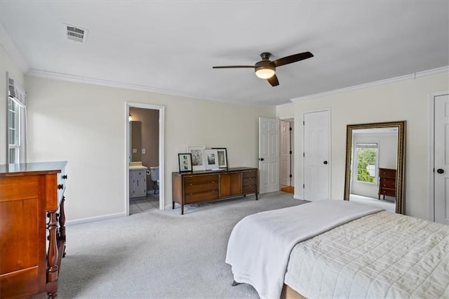 4255 Hidden Meadow Cir, Sugar Hill, GA 30518 - carpeted bedroom featuring crown molding, baseboards, two closets, a ceiling fan, and connected bathroom