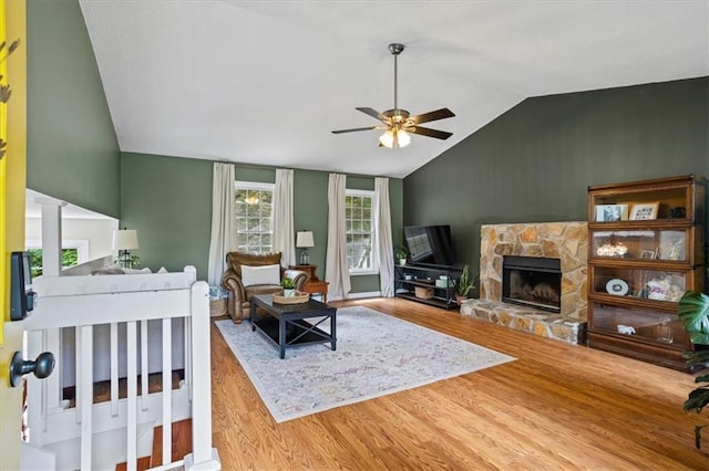 4255 Hidden Meadow Cir, Sugar Hill, GA 30518 - living area with vaulted ceiling, a ceiling fan, wood finished floors, and a fireplace