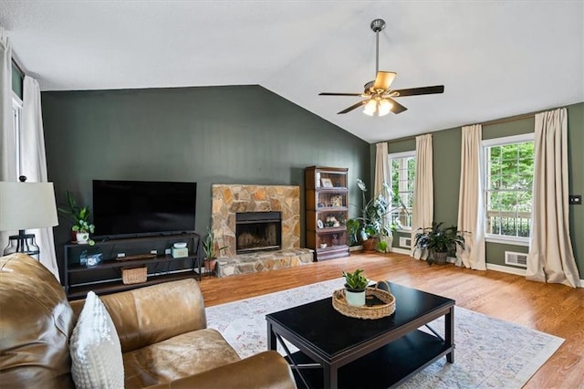 4255 Hidden Meadow Cir, Sugar Hill, GA 30518 - living room with ceiling fan, a stone fireplace, lofted ceiling, and wood finished floors