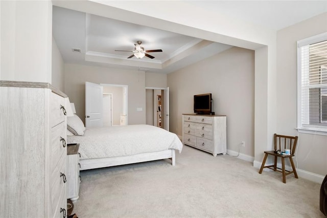 bedroom with ceiling fan, carpet, and a tray ceiling