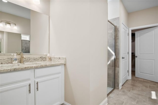 bathroom featuring vanity, walk in shower, and tile patterned flooring