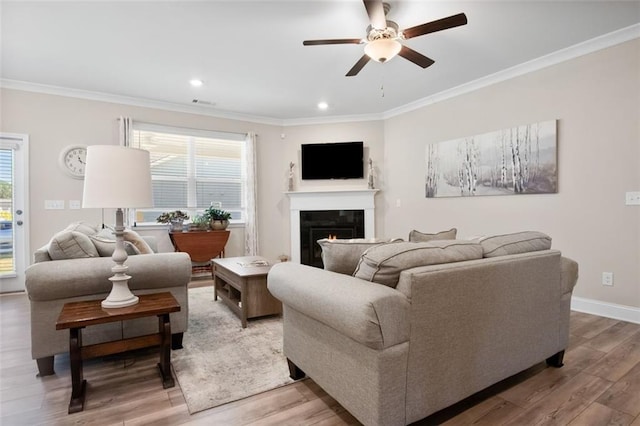 living room featuring ornamental molding, hardwood / wood-style flooring, and ceiling fan