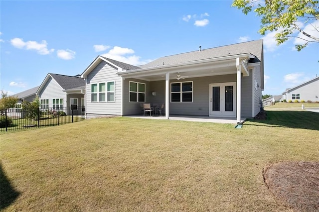 rear view of property with a yard, a patio area, and ceiling fan