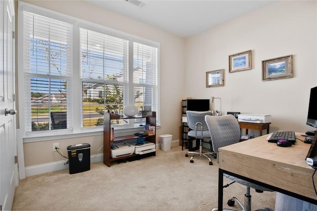 office with a healthy amount of sunlight and light colored carpet