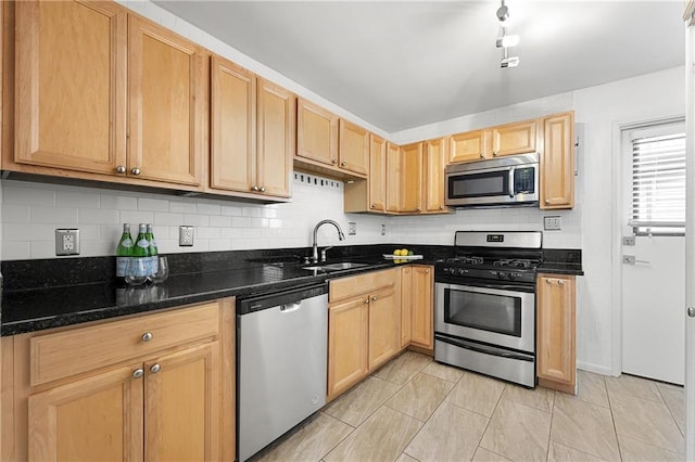 1355 Euclid Ave NE Unit A8, Atlanta, GA 30307 - kitchen featuring appliances with stainless steel finishes, backsplash, light tile patterned flooring, dark stone counters, and light brown cabinets