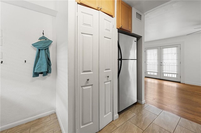1355 Euclid Ave NE Unit A8, Atlanta, GA 30307 - kitchen with freestanding refrigerator, french doors, and light tile patterned floors