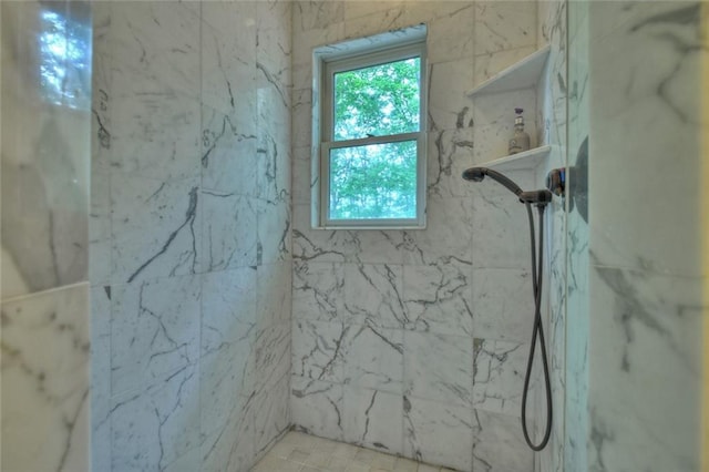 bathroom featuring a tile shower