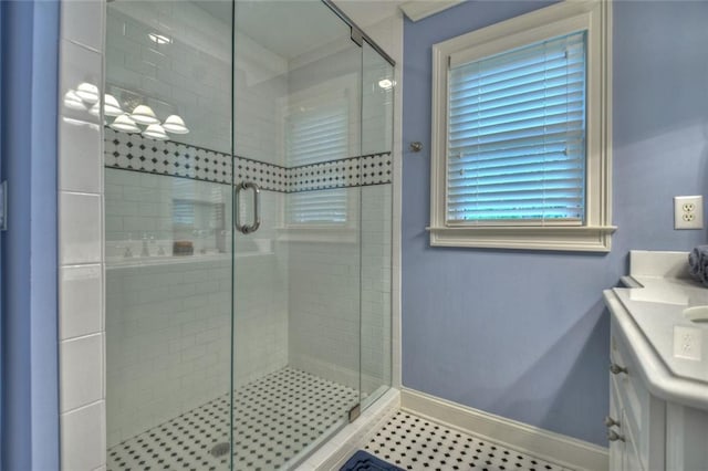 bathroom featuring vanity and an enclosed shower