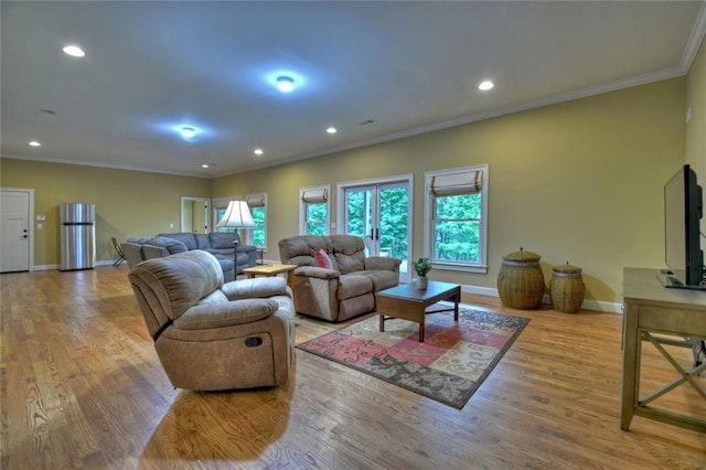 living room featuring light hardwood / wood-style flooring and ornamental molding