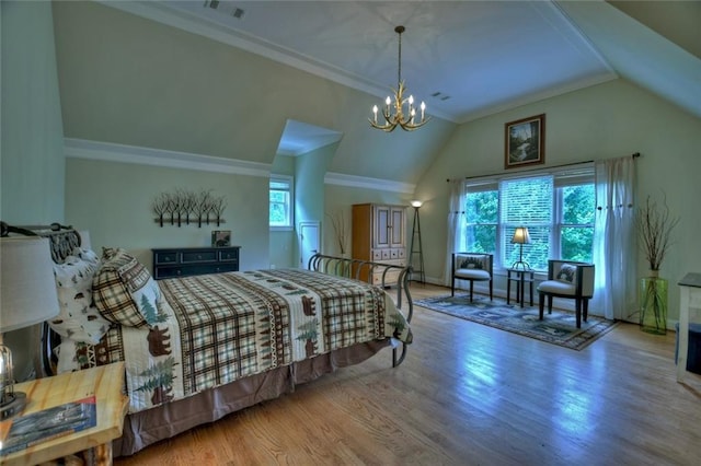 bedroom featuring hardwood / wood-style flooring, lofted ceiling, crown molding, and a chandelier