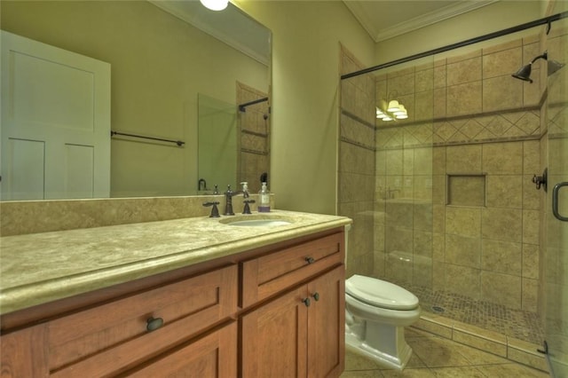 bathroom with crown molding, vanity, tile patterned floors, toilet, and walk in shower