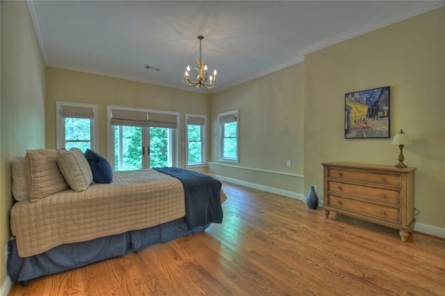 bedroom with hardwood / wood-style flooring, crown molding, and a notable chandelier