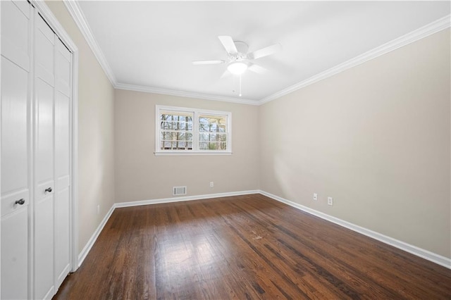 unfurnished bedroom featuring dark hardwood / wood-style floors, ornamental molding, a closet, and ceiling fan