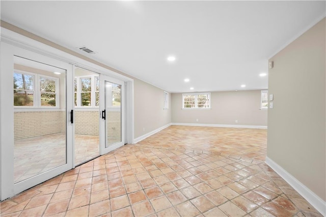 unfurnished room with light tile patterned flooring