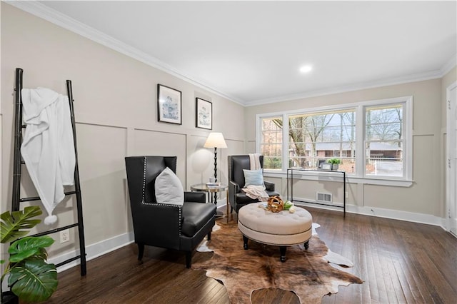 sitting room with crown molding and dark hardwood / wood-style flooring