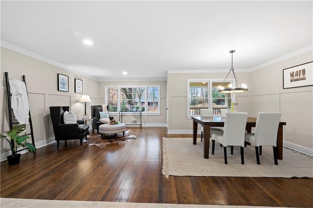 dining space with crown molding, dark wood-type flooring, and a notable chandelier