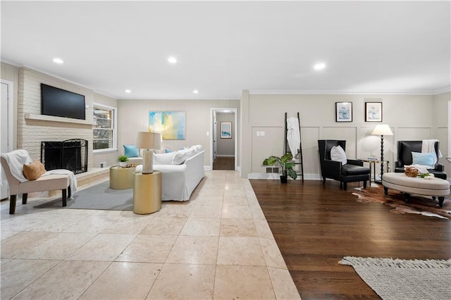tiled living room featuring a fireplace and ornamental molding