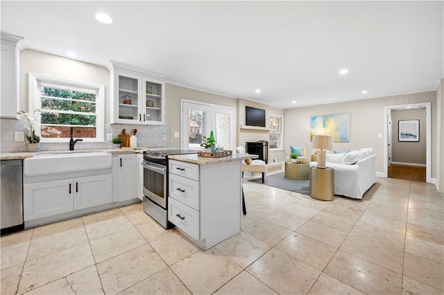 kitchen featuring white cabinetry, appliances with stainless steel finishes, plenty of natural light, and sink