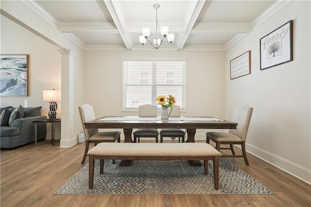 dining area featuring beam ceiling, light wood-type flooring, baseboards, and decorative columns