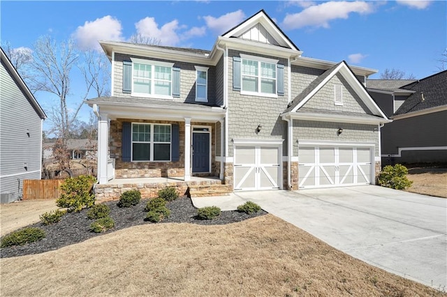 craftsman inspired home featuring stone siding, driveway, an attached garage, and fence