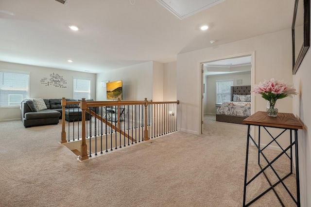 hall featuring an upstairs landing, carpet flooring, recessed lighting, and attic access