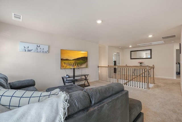 living area featuring visible vents, baseboards, and carpet flooring