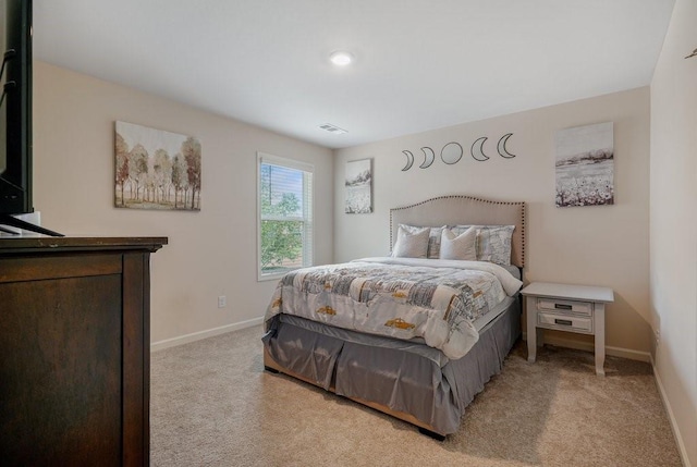 bedroom featuring visible vents, baseboards, and light colored carpet