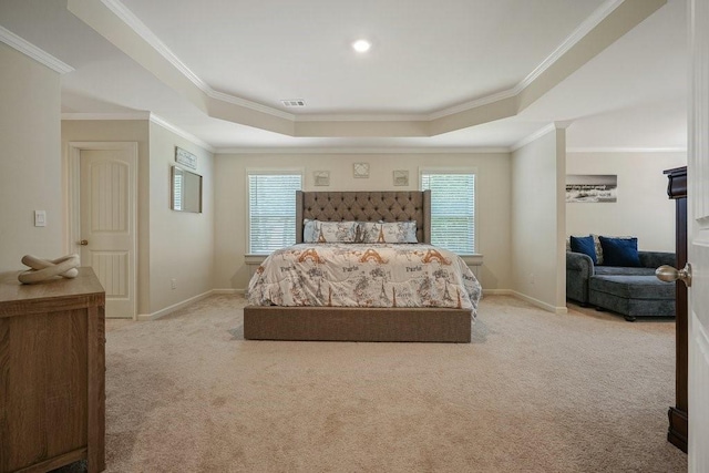 bedroom with a tray ceiling, multiple windows, and carpet flooring