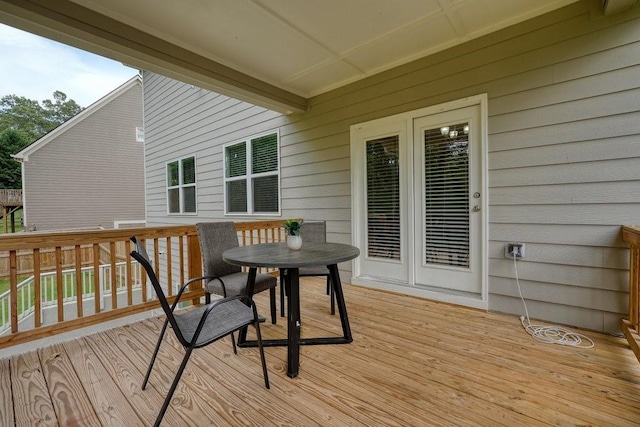 wooden terrace featuring outdoor dining space