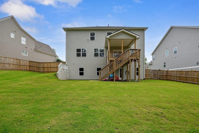 back of house featuring stairs, a yard, a fenced backyard, and a wooden deck