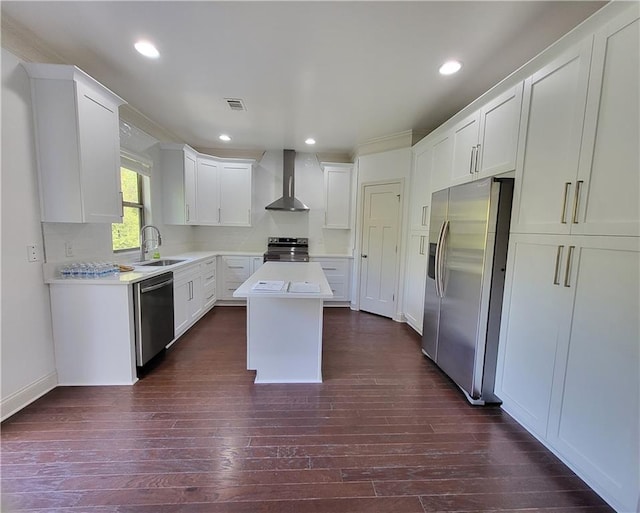 kitchen with appliances with stainless steel finishes, dark hardwood / wood-style floors, sink, wall chimney exhaust hood, and a center island