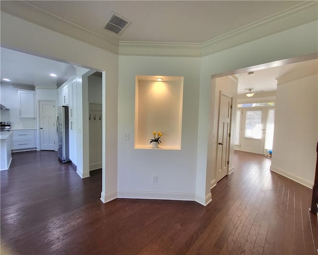 hallway with dark wood-type flooring and ornamental molding