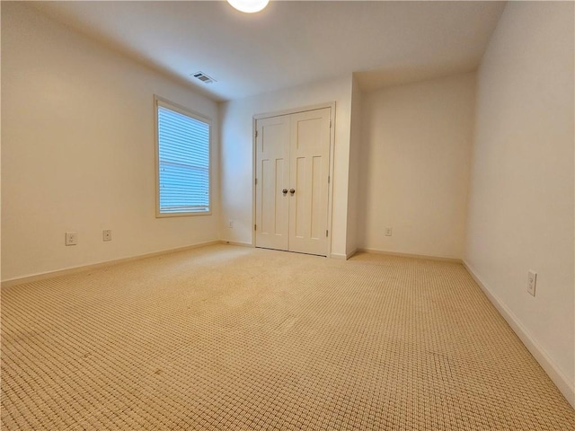 unfurnished bedroom with light colored carpet