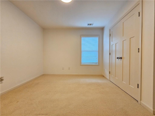 unfurnished bedroom with light colored carpet