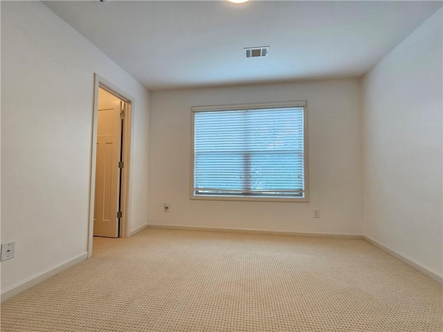 empty room featuring light carpet