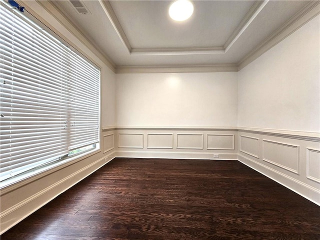 unfurnished room with crown molding, dark hardwood / wood-style floors, and a raised ceiling