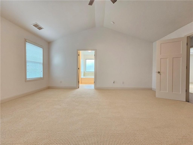 empty room with light carpet, ceiling fan, and vaulted ceiling