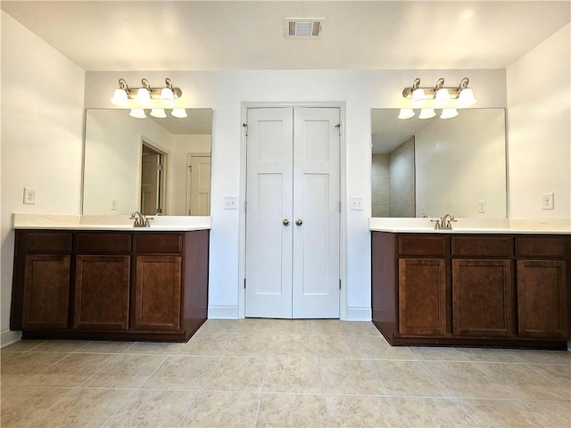 bathroom with vanity and tile patterned floors