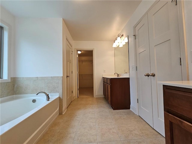 bathroom with vanity, a tub, and tile patterned flooring