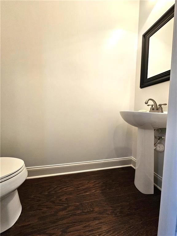 bathroom with wood-type flooring and toilet