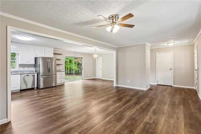 unfurnished living room featuring ceiling fan, dark hardwood / wood-style flooring, a textured ceiling, and crown molding