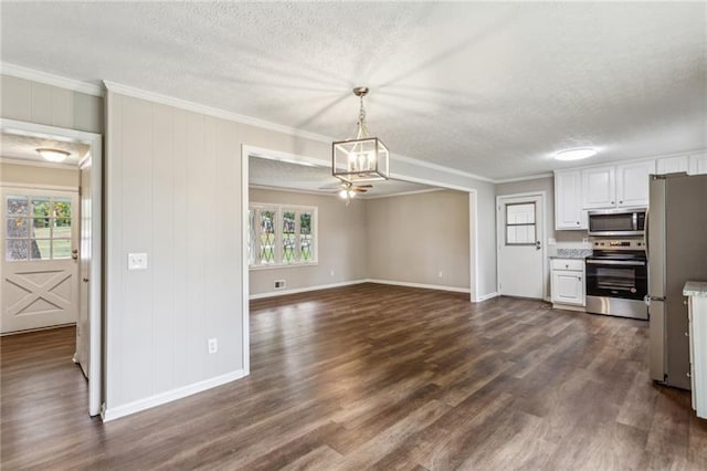 kitchen with white cabinets, appliances with stainless steel finishes, hanging light fixtures, and crown molding